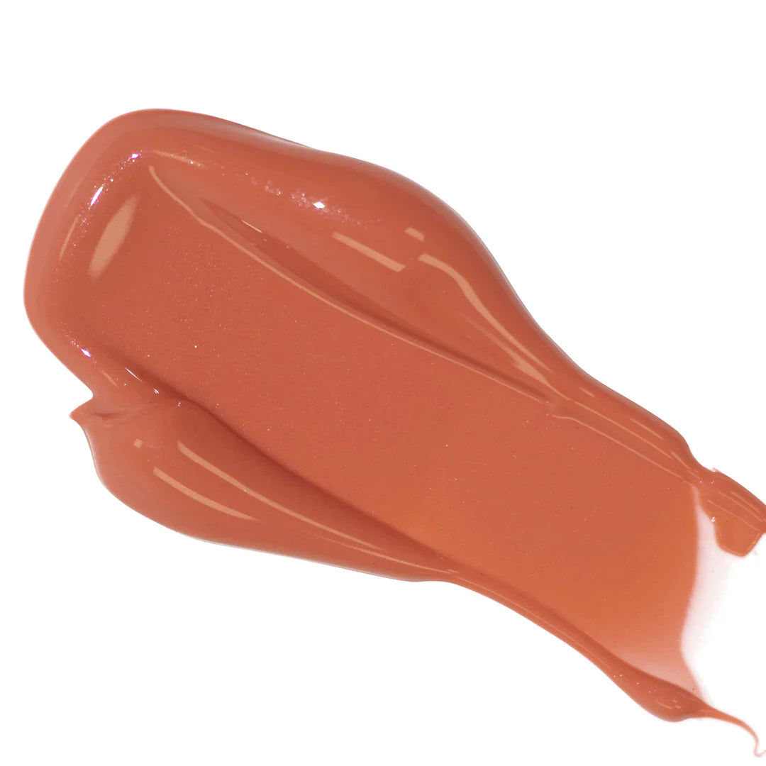 Smear of glossy brown lipstick on a white background.