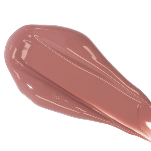 A smear of creamy brown lipstick against a white background.